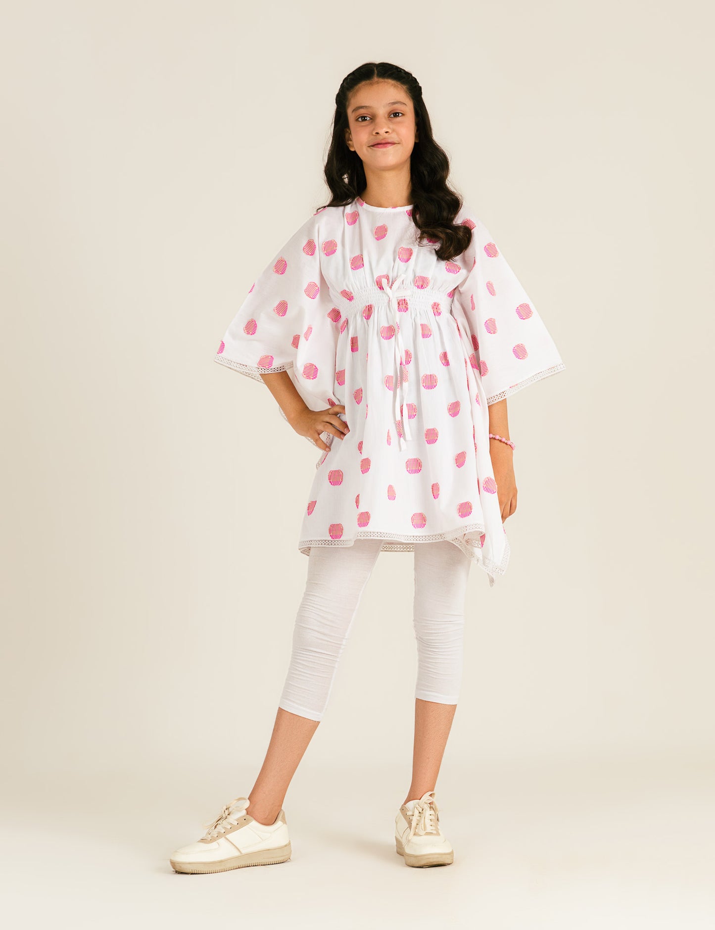 JACQUARD PONCHO WITH SMOCKING DETAIL