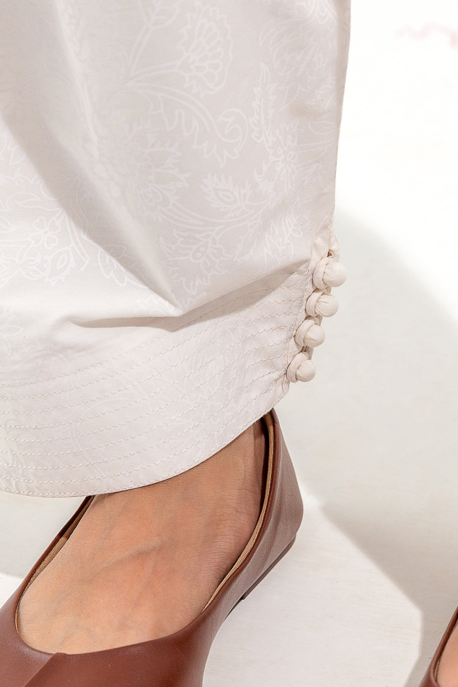 Fashionable trousers showcasing unique screen-printed pattern and loops.