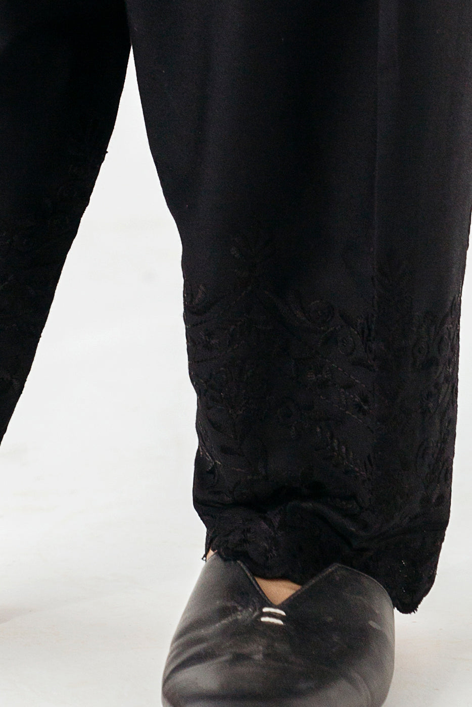 "Chic black trousers with intricate embroidery along the border