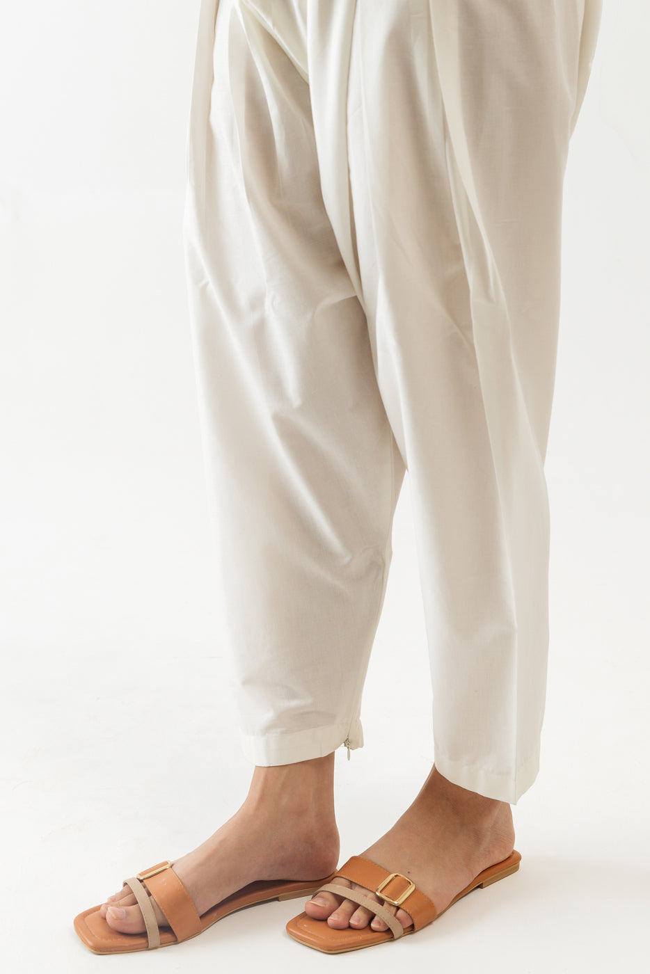 Off-white pleated shalwar featuring a side zip for easy wear.