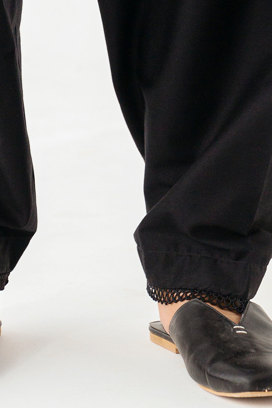 Chic trousers adorned with delicate lace detailing.