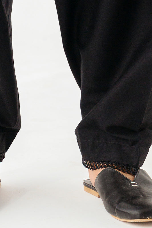 Chic trousers adorned with delicate lace detailing.