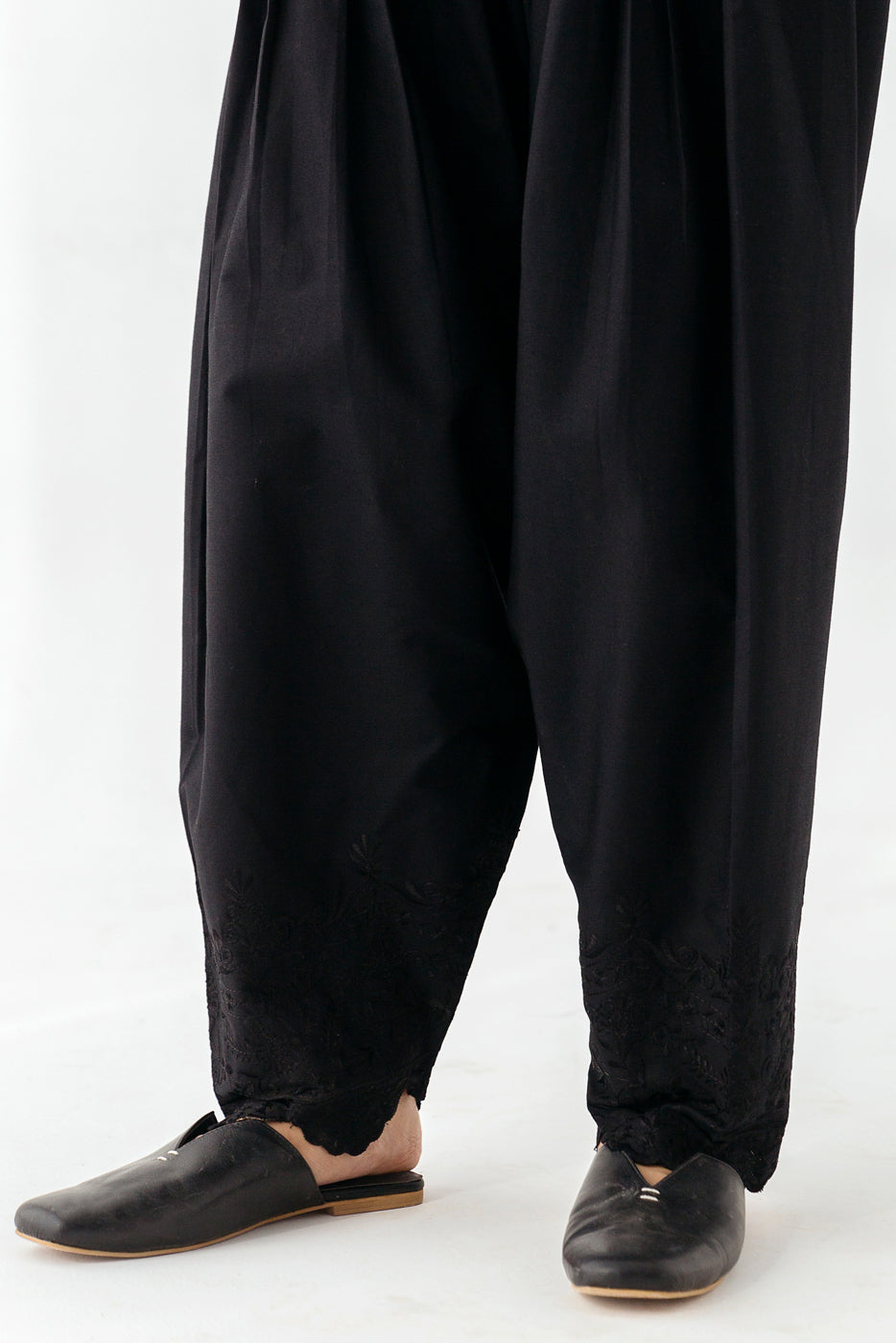 Black shalwar featuring ornate embroidered border."